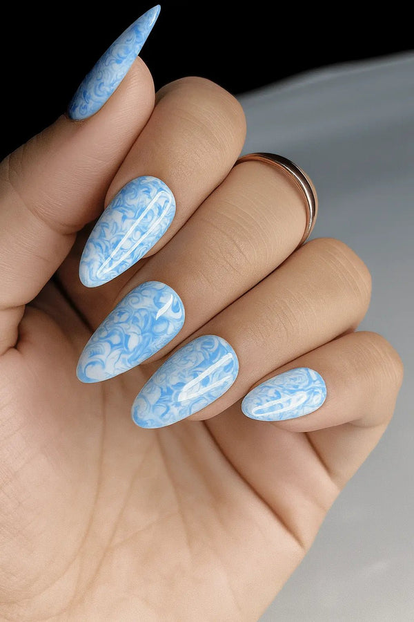Blue marble nail art design fake artificial nails in almond shape with white background