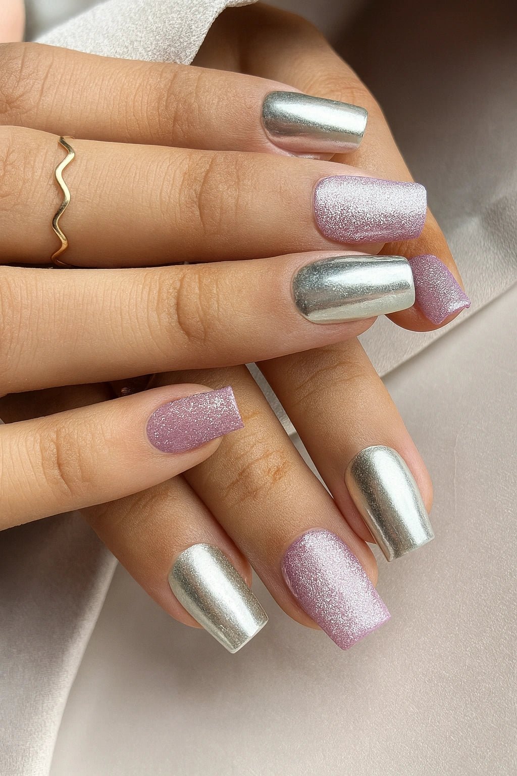 A Press on nails set of pastel lavender cat eye and silver chrome fake nails
