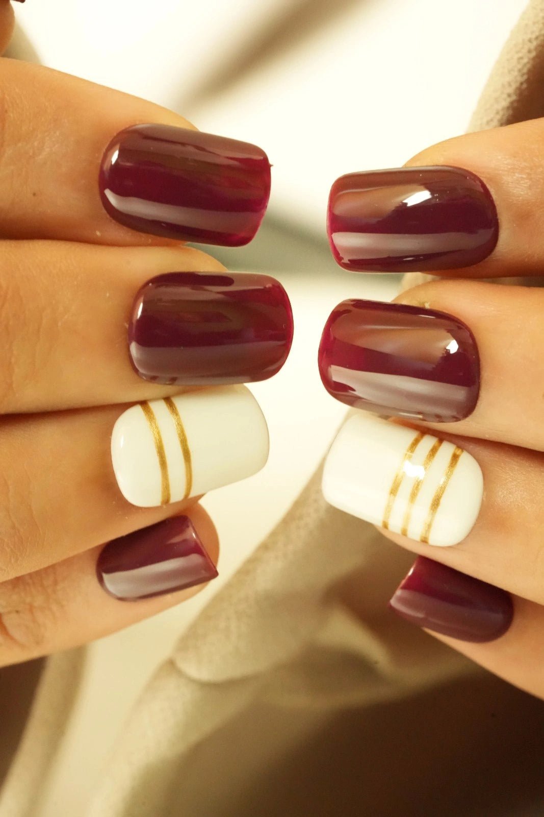 Close-up of hands with best maroon bridal short square press on nails
