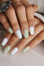 These is our mint green press on nails set named Polka Pearl. These nails carry a french art, dot art and the stone art on fingernails. This mint green set has different design on each finger and also on the thumb, Where all fingers carry a design the thumb carry a floral rhinestone art.
