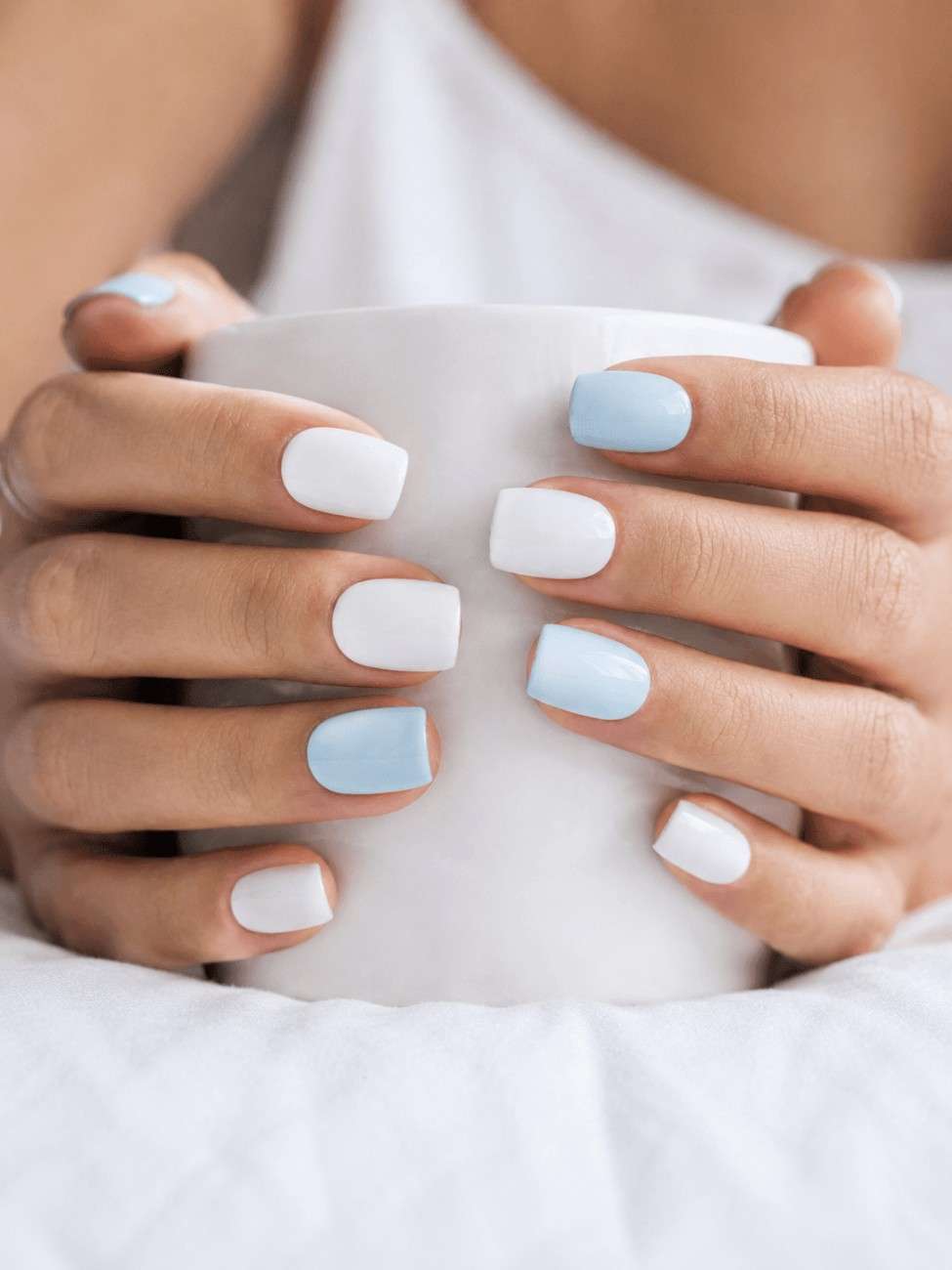 Cloud Blue reusable press-on nails worn on hand