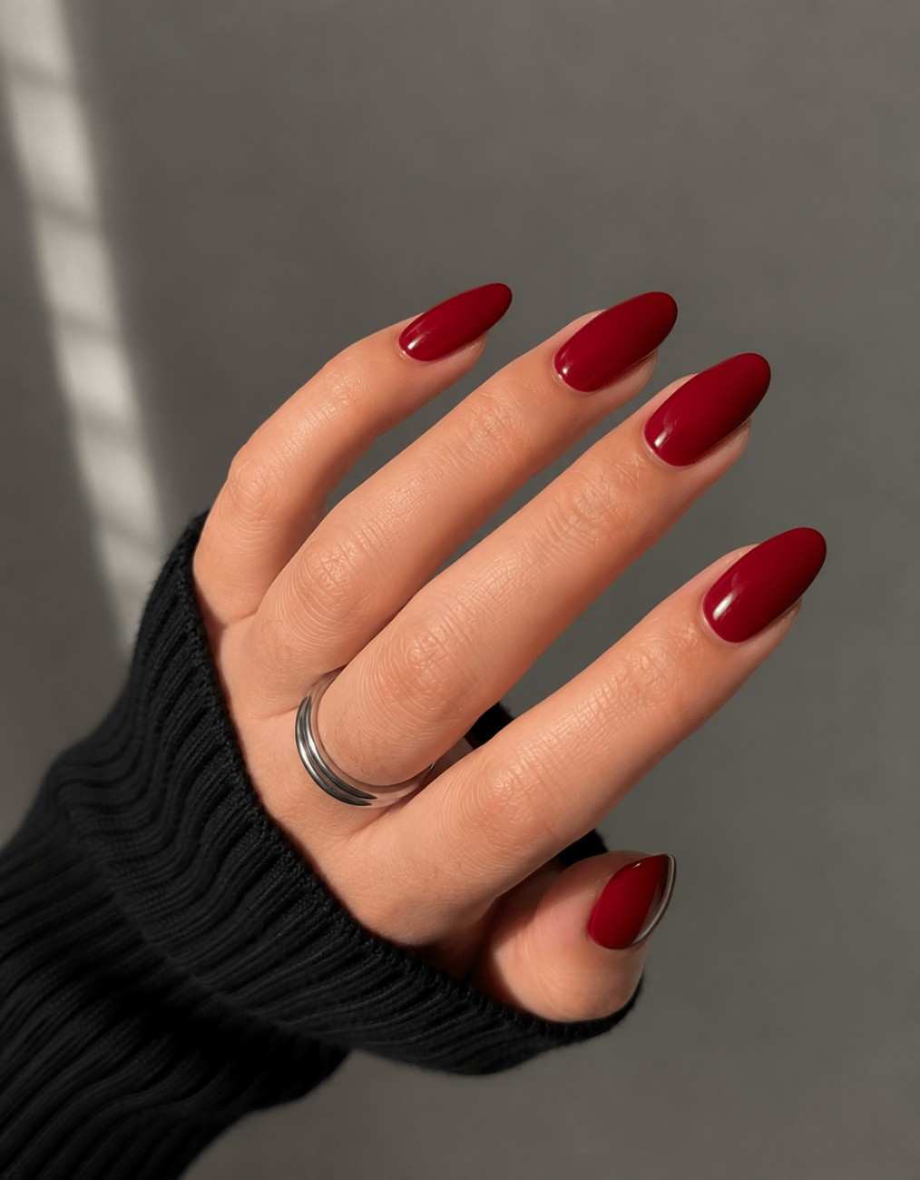 Crimson Classic red press-on nails worn on hand