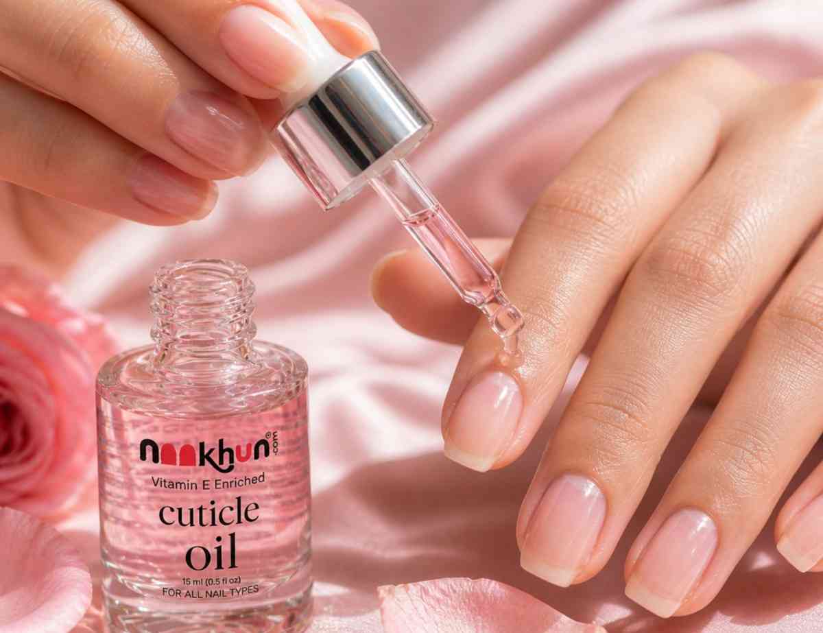 Applying cuticle oil to hydrate dry cuticles and strengthen nails