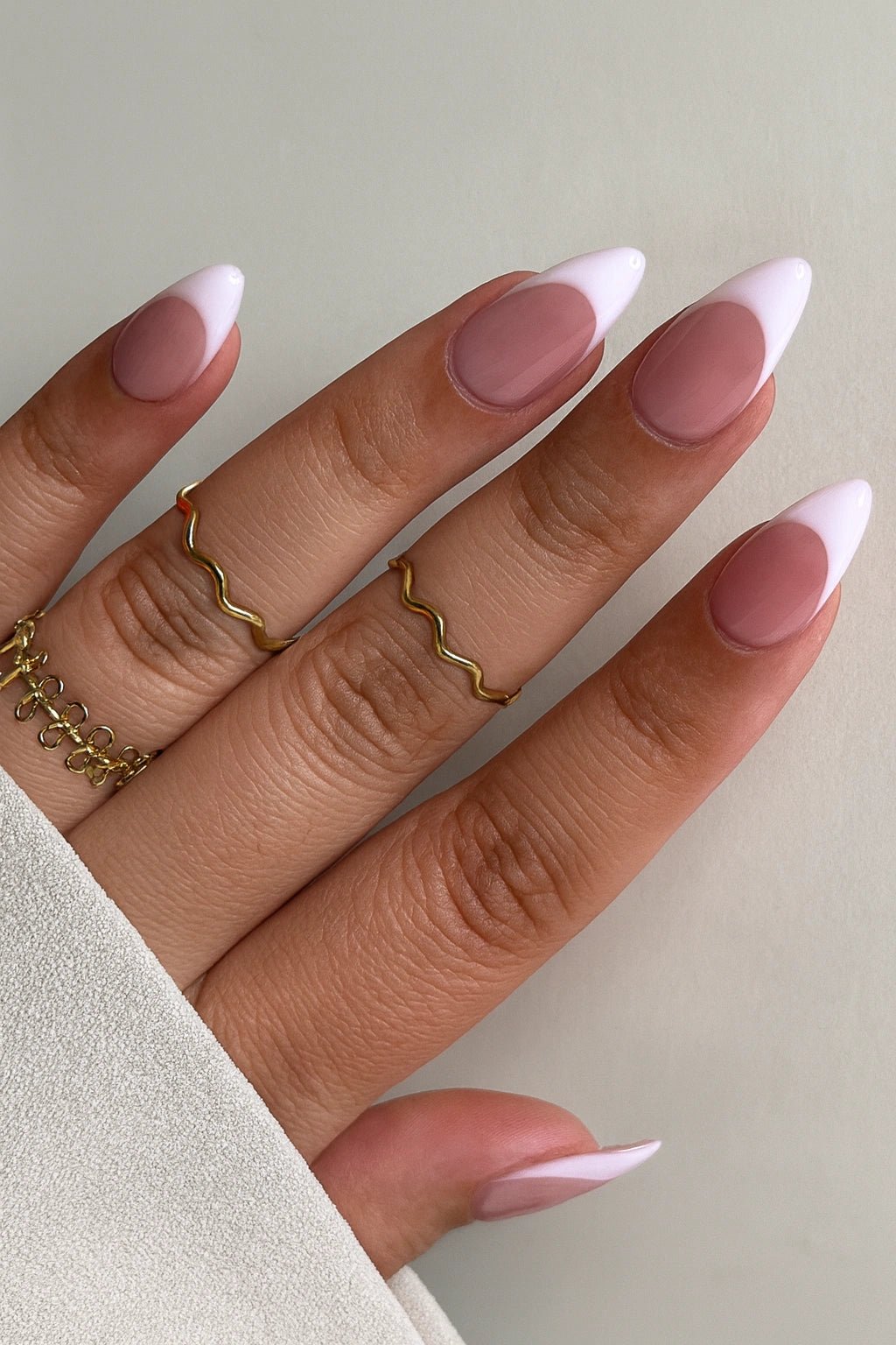 closeup of deep french tip press on nails which are with a nude base colour