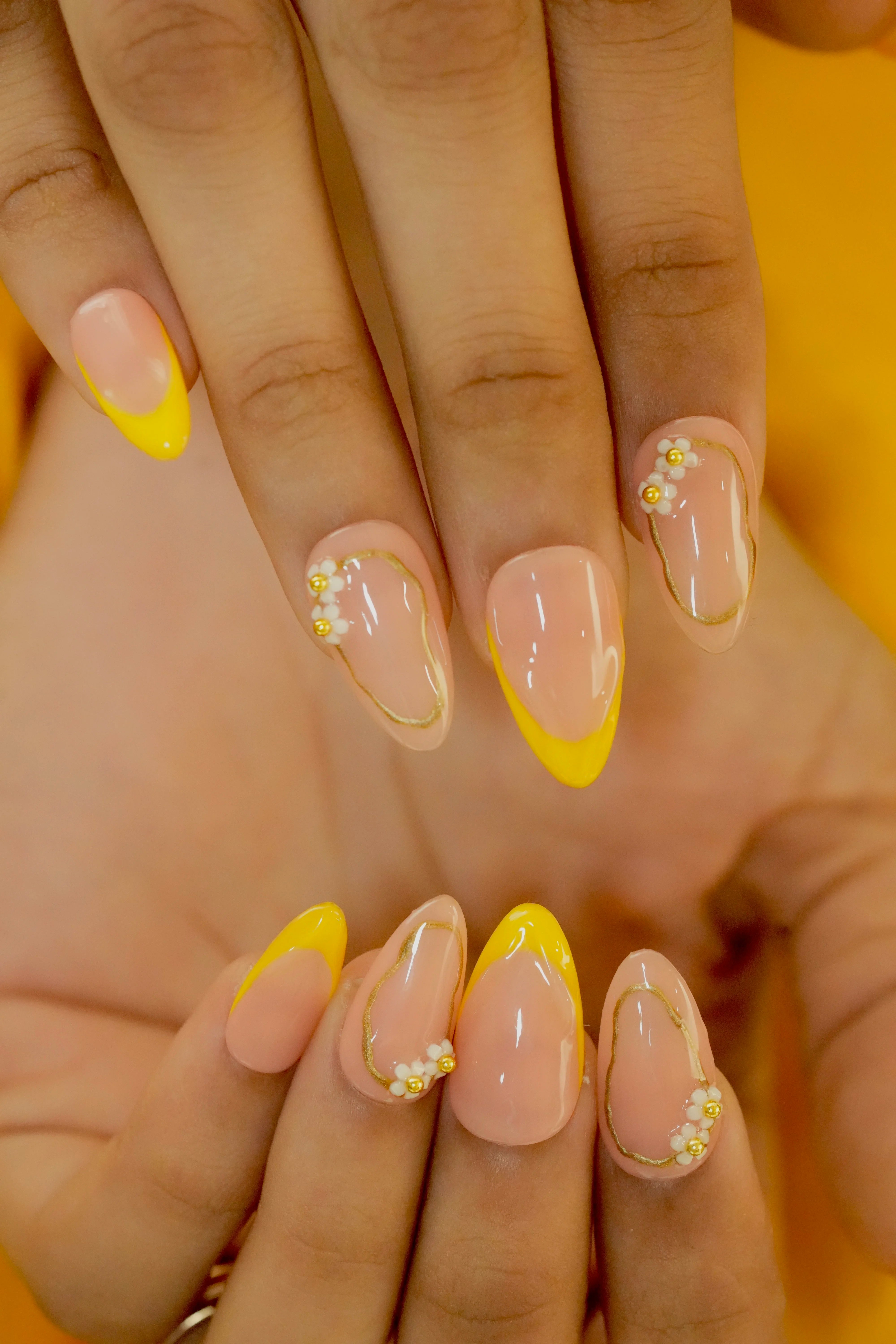 Floral French tip nails with pearl and rhinestone accents