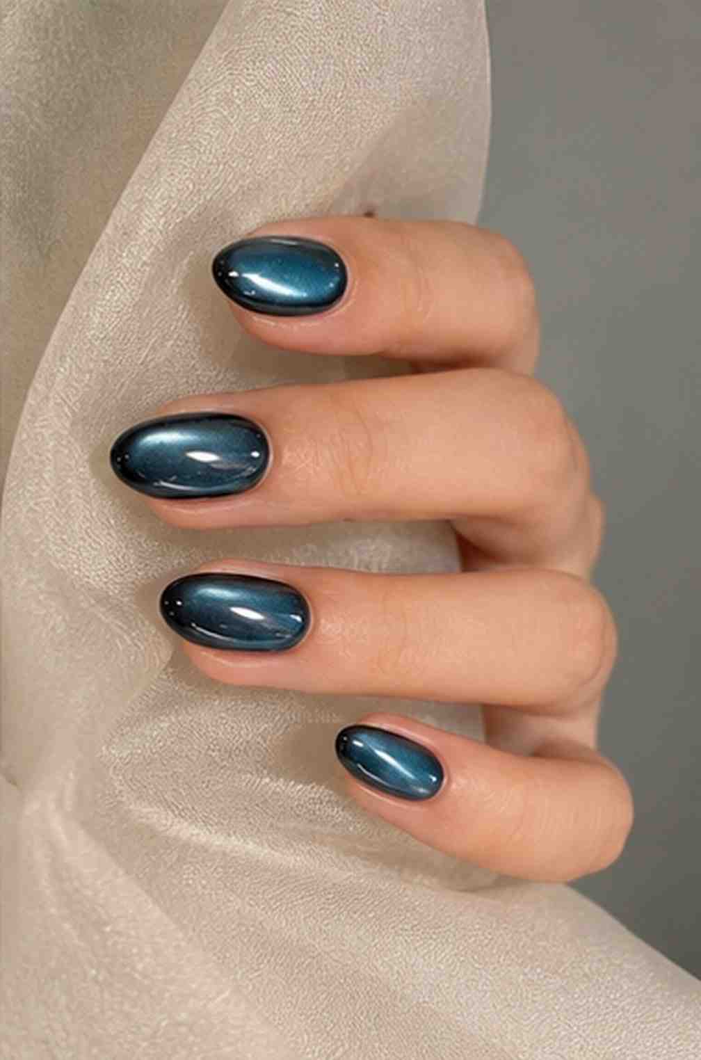Green Galaxy press-on nails worn on hand with a bold green cat-eye effect and glossy finish.