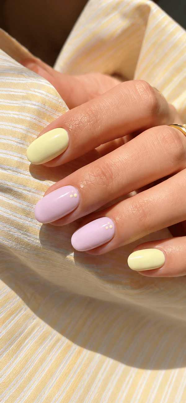 Close-up of Honey Petal lemon yellow, pastel lavender and pink press-on nails