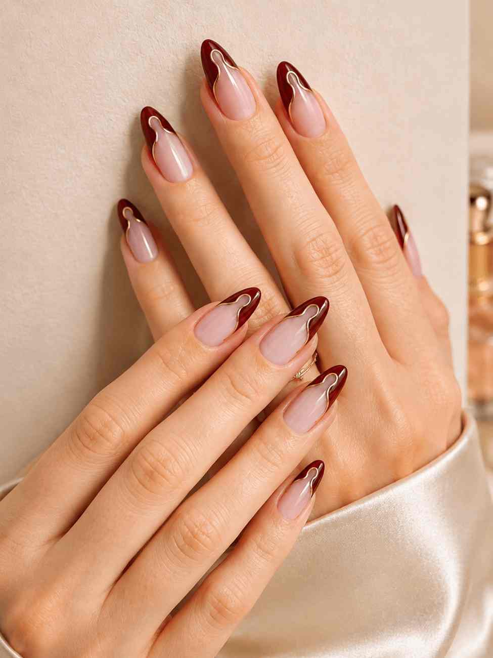 Ruby Waves dark wine press-on nails worn on hand