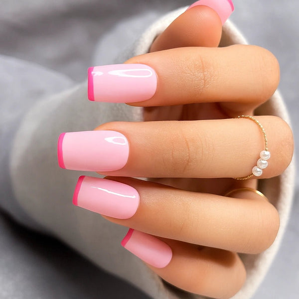 Hand with pink french on light pink base colour fake nails