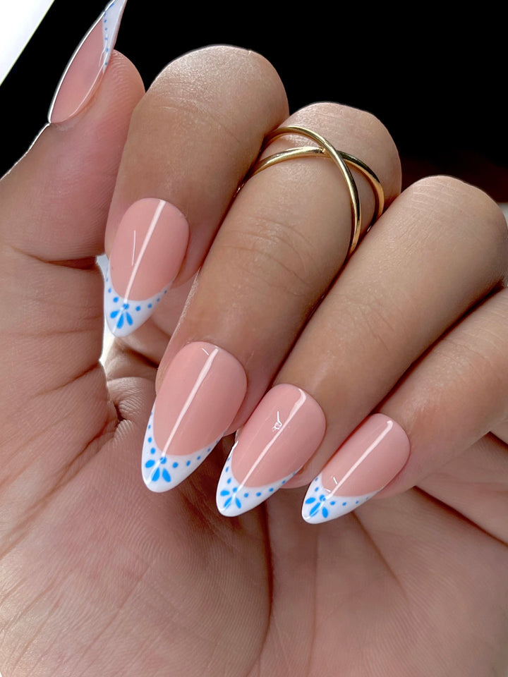 White French tip press-on nails with almond shape and pink base


