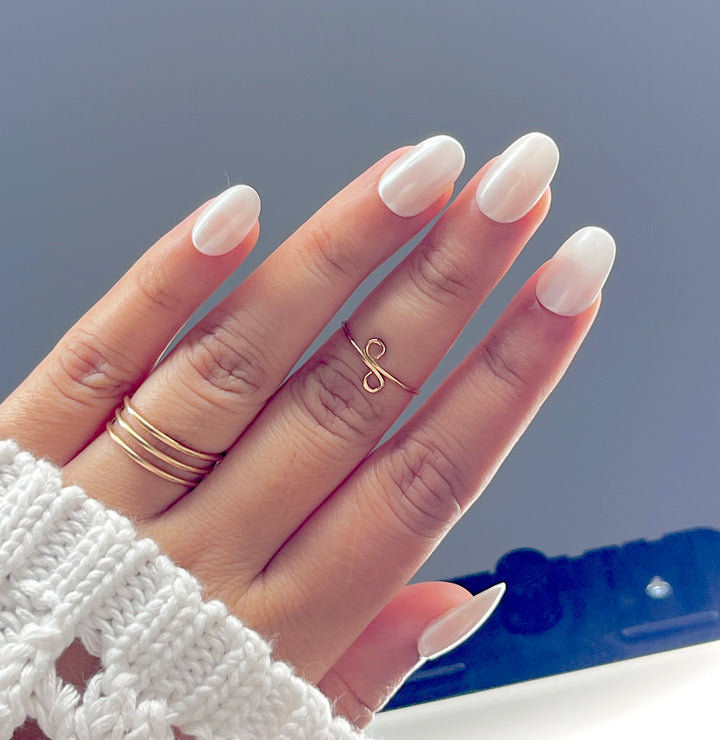 showing how these White silver chrome short round fake press on nails look in light their fall in look